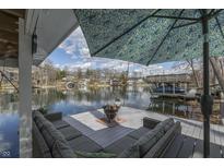 Covered deck with comfortable seating and a picturesque lake view at 7668 Heather Dr, Nineveh, IN 46164