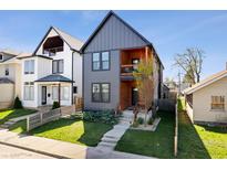 Attractive home with charcoal gray siding, natural wood accents and a small front yard at 807 E Minnesota St, Indianapolis, IN 46203