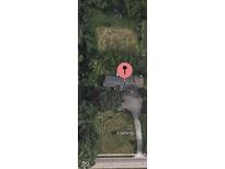 Aerial view of property at 8560 E 38th St, featuring a spacious lot, mature trees, and a private driveway at 8560 E 38Th St, Indianapolis, IN 46226