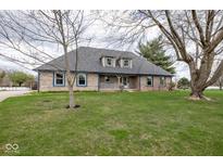 Charming brick home with a well-manicured lawn and mature trees, perfect for Gathering living at 8883 Cindy Ln, Brownsburg, IN 46112