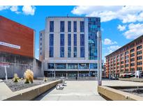 This building features a unique facade with a mix of glass and concrete, set against a beautiful blue sky at 1 Virginia Ave # 707, Indianapolis, IN 46204
