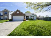 Charming one-story home features a manicured lawn and attached two-car garage at 14203 Cliffwood Pl, Fishers, IN 46038