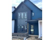 Modern two-story home showcasing a stylish blue exterior, black window frames, and brick accents at 16387 Burlwood Dr, Westfield, IN 46074