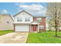 Charming two-story home featuring a brick and vinyl facade, attached garage, and a well-maintained lawn at 1839 Silverton Dr, Avon, IN 46123