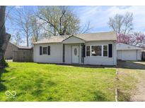 Charming single-story home with manicured lawn and inviting front entrance at 1933 Ruth Dr, Indianapolis, IN 46240