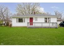 Charming single-story home with a red front door, white siding, and a well-manicured lawn at 217 S 17Th Ave, Beech Grove, IN 46107