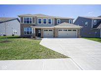 Stunning two-story brick home with a spacious three-car garage and well-manicured front yard at 2237 S Copperstone Dr, New Palestine, IN 46163
