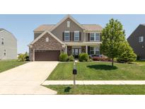 Inviting two-story home with a well-maintained lawn, complemented by a brick-accented facade and a two-car garage at 2325 Silver Rose Dr, Avon, IN 46123