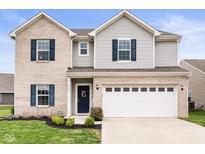 Charming two-story home with brick accents, gray siding, and a spacious two-car garage at 2681 Pumpkin Patch Ln, Indianapolis, IN 46229