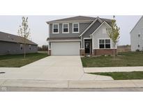 Charming two-story home with gray siding, a spacious driveway, and an attached two-car garage at 2704 Grassy Br Dr, Whitestown, IN 46075