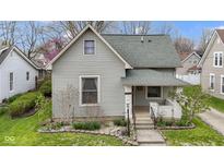 Charming home with gray siding, green roof, landscaped yard, and a welcoming front porch at 304 W 4Th St, Greenfield, IN 46140