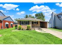 Charming brick home with green lawn and convenient covered parking at 3809 Wildwood Dr, Indianapolis, IN 46239
