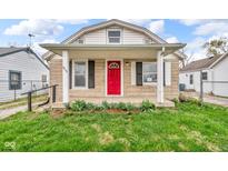 Charming home featuring a red front door, stone accents, and a covered porch at 4618 W Beecher St, Indianapolis, IN 46241