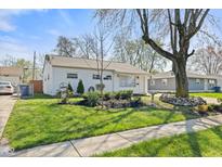 Charming single-story home with a well-manicured front yard and mature landscaping at 4833 N Kenyon Dr, Indianapolis, IN 46226