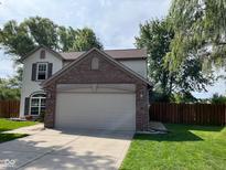 Charming two-story home featuring a brick two-car garage, well-maintained lawn, and mature trees, offering great curb appeal at 563 Jet Stream Blvd, Westfield, IN 46074