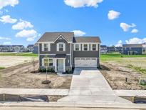 Charming two-story home with a light blue door and an attached two-car garage at 7167 Finley Creek Dr, Whitestown, IN 46075