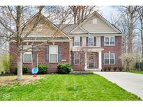 Charming brick home with well-manicured lawn, a swing, and classic architectural details and colors at 7714 Black Walnut Dr, Avon, IN 46123