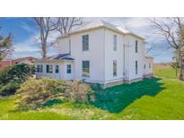 Charming two-story home with mature landscaping and a well-maintained lawn at 10723 E State Road 234, Wilkinson, IN 46186