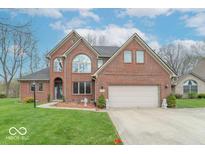 Charming two-story brick home with well-manicured lawn and attached two-car garage at 130 George Ct, Danville, IN 46122