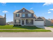 Charming two-story home with a manicured lawn and a two-car garage on a sunny day at 145 Stamford Dr, Pittsboro, IN 46167