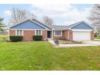 Charming single-story brick home featuring a well-manicured lawn and attached two-car garage at 1737 W 200 N, Greenfield, IN 46140