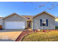 Charming ranch-style home with a well-manicured lawn and attached two-car garage at 19545 Amber Way, Noblesville, IN 46060