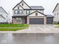 Charming two-story home features a 3-car garage and a welcoming brick facade at 20398 N Pacific Ave, Westfield, IN 46074