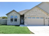 Charming single-story brick home with a well-manicured lawn and a two-car garage at 2144 Connie Ct, Franklin, IN 46131