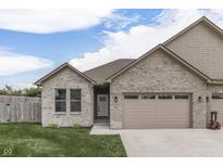 Charming brick home featuring a two-car garage, manicured lawn, and inviting entrance at 2144 Connie Ct, Franklin, IN 46131