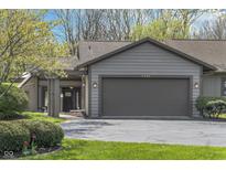 Charming home featuring a two-car garage, manicured lawn, and welcoming entryway at 2305 Van Ness Pl, Indianapolis, IN 46240