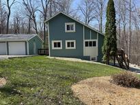 Two story home featuring unique architecture, bright white windows, and charming blue siding at 3764 E Glenwood Dr, Martinsville, IN 46151