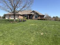 Beautiful brick home featuring a well-manicured lawn and an attached three-car garage at 415 N Westview Dr, Columbus, IN 47201