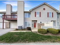 Charming two-story home with red shutters, attached garage, and small front yard at 4630 Kelvington Dr, Indianapolis, IN 46254