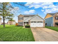 Charming two-story home boasts a manicured lawn, two-car garage, and inviting curb appeal at 5223 Jerry Ct, Indianapolis, IN 46254
