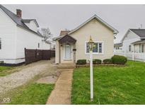 Charming single-story home with a well-manicured lawn and cozy covered entryway at 709 S A St, Elwood, IN 46036