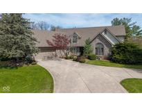 Charming brick home featuring an attached garage, mature trees, and a concrete driveway at 7371 Windridge Way, Brownsburg, IN 46112