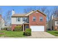 Charming two-story home with a combination of red brick and gray siding at 7418 Bluebird Ct, Indianapolis, IN 46254