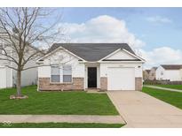 Well-maintained single-story home featuring a one-car garage, brick accents, and a neatly manicured front lawn at 8529 Sansa St, Camby, IN 46113