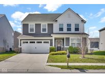 Charming two-story home with a well-manicured lawn, two-car garage and lovely landscaping at 10319 Pronghorn Ln, Indianapolis, IN 46239