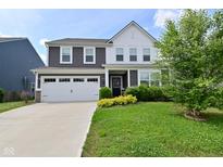 Charming two-story home with gray and white siding, two-car garage, and a well-manicured lawn at 10319 Pronghorn Ln, Indianapolis, IN 46239