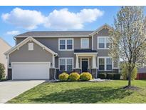 Charming two-story home with a well-maintained lawn and landscaping, showcasing curb appeal at 1575 Oakvista Dr, Greenwood, IN 46143