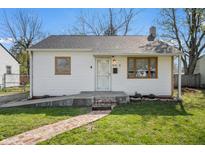 Charming single-story home with a brick walkway, white siding, and well-maintained front lawn at 2221 Groff Ave, Indianapolis, IN 46222
