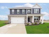 Charming two-story home with blue siding, stone accents, and a well-manicured lawn at 2538 Redding Dr, Whitestown, IN 46075