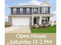 Charming two-story home featuring a covered porch, attached two-car garage and beautiful lawn at 2538 Redding Dr, Whitestown, IN 46075