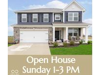 Charming two-story home features a covered front porch, stone accents, and a well-maintained lawn, perfect for suburban living at 2538 Redding Dr, Whitestown, IN 46075
