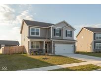 Charming two-story home featuring gray siding, a two-car garage, and a well-manicured front lawn at 2960 W Patchwork Dr, Monrovia, IN 46157
