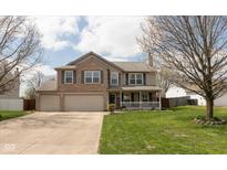 Charming two-story home with a well-manicured lawn and a welcoming front porch at 464 Hummingbird Ln, Whiteland, IN 46184