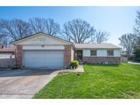 Charming single-story home featuring a brick facade, attached garage, and a well-maintained front yard at 617 Kokomo Ln, Indianapolis, IN 46241