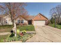 Charming ranch home with a well-manicured lawn, beautiful landscaping, and an attached two-car garage at 6174 Bristlecone Dr, Fishers, IN 46038