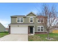Charming two-story home featuring an attached two-car garage and manicured lawn at 6316 Avacado Dr, Indianapolis, IN 46217